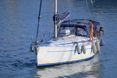 Italy, Sicily, Mediterranean Sea, Marina di Ragusa (Ragusa Province); 28 August 2022, couple on a sailing boat in the port - EDITORIAL