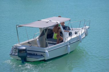 Italy, Sicily, Mediterranean Sea, Marina di Ragusa (Ragusa Province); 31 August 2022, people on a motor boat in the port - EDITORIAL