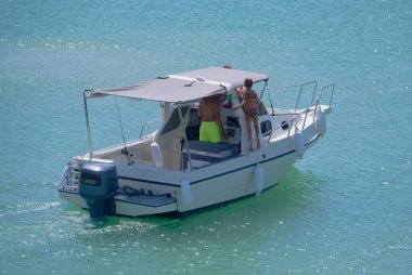 Italy, Sicily, Mediterranean Sea, Marina di Ragusa (Ragusa Province); 31 August 2022, people on a motor boat in the port - EDITORIAL