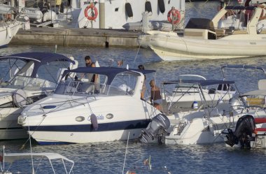 Italy, Sicily, Mediterranean sea, Marina di Ragusa (Ragusa Province); 2 September 2022, people, motor boats and luxury yachts in the port - EDITORIAL