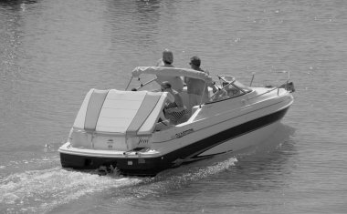 Italy, Sicily, Mediterranean Sea, Marina di Ragusa (Ragusa Province); 3 September 2022, people on a motor boat in the port - EDITORIAL