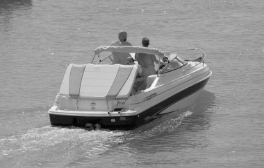 Italy, Sicily, Mediterranean Sea, Marina di Ragusa (Ragusa Province); 3 September 2022, people on a motor boat in the port - EDITORIAL