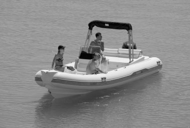Italy, Sicily, Mediterranean Sea, Marina di Ragusa (Ragusa Province); 3 September 2022, people on a rubber boat in the port - EDITORIAL