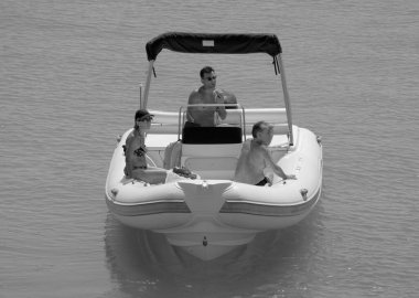Italy, Sicily, Mediterranean Sea, Marina di Ragusa (Ragusa Province); 3 September 2022, people on a rubber boat in the port - EDITORIAL