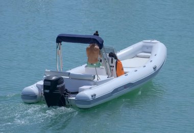 Italy, Sicily, Mediterranean Sea, Marina di Ragusa (Ragusa Province); 3 September 2022, couple on a rubber boat in the port - EDITORIAL