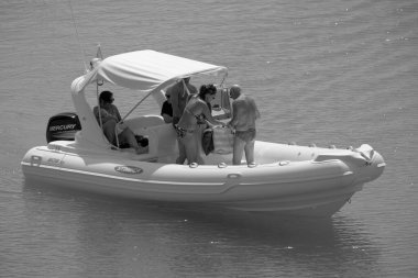 Italy, Sicily, Mediterranean Sea, Marina di Ragusa (Ragusa Province); 3 September 2022, people on a rubber boat in the port - EDITORIAL