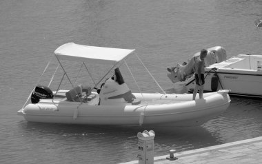 Italy, Sicily, Mediterranean Sea, Marina di Ragusa (Ragusa Province); 3 September 2022, man on a rubber boat in the port - EDITORIAL