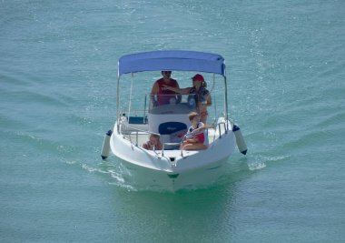 Italy, Sicily, Mediterranean Sea, Marina di Ragusa (Ragusa Province); 4 September 2022, people on a motor boat in the port - EDITORIAL