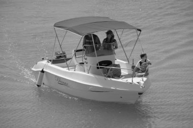 Italy, Sicily, Mediterranean Sea, Marina di Ragusa (Ragusa Province); 4 September 2022, people on a motor boat in the port - EDITORIAL