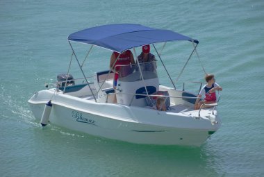 Italy, Sicily, Mediterranean Sea, Marina di Ragusa (Ragusa Province); 4 September 2022, people on a motor boat in the port - EDITORIAL