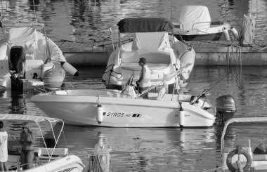 Italy, Sicily, Mediterranean Sea, Marina di Ragusa (Ragusa Province); 3 September 2022, sport fisherman on a motor boat in the port - EDITORIAL