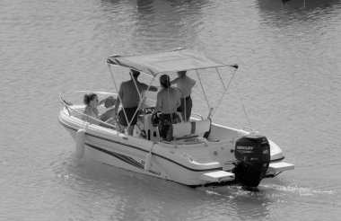 Italy, Sicily, Mediterranean Sea, Marina di Ragusa (Ragusa Province); 4 September 2022, people on a motor boat in the port - EDITORIAL