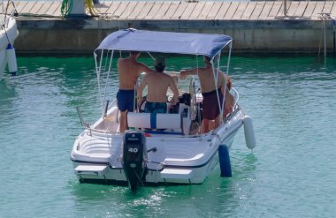 Italy, Sicily, Mediterranean Sea, Marina di Ragusa (Ragusa Province); 4 September 2022, people on a motor boat in the port - EDITORIAL