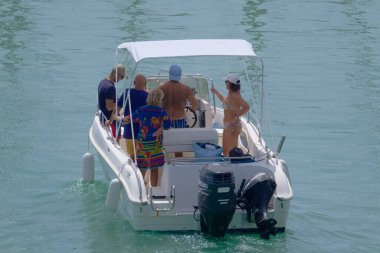 Italy, Sicily, Mediterranean Sea, Marina di Ragusa (Ragusa Province); 4 September 2022, people on a motor boat in the port - EDITORIAL