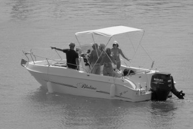 Italy, Sicily, Mediterranean Sea, Marina di Ragusa (Ragusa Province); 4 September 2022, people on a motor boat in the port - EDITORIAL