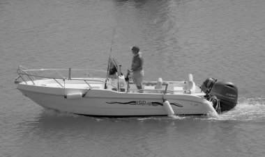 Italy, Sicily, Mediterranean Sea, Marina di Ragusa (Ragusa Province); 4 September 2022, sport fisherman on a motor boat in the port - EDITORIAL