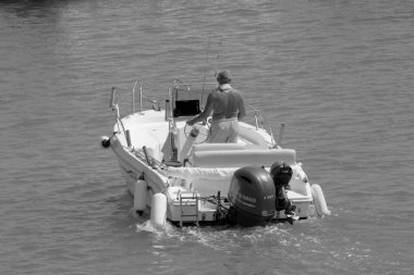 Italy, Sicily, Mediterranean Sea, Marina di Ragusa (Ragusa Province); 4 September 2022, sport fisherman on a motor boat in the port - EDITORIAL