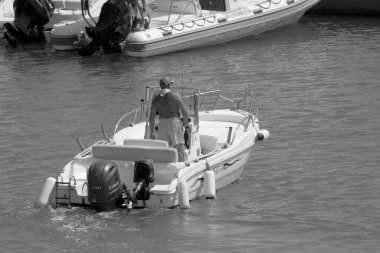 Italy, Sicily, Mediterranean Sea, Marina di Ragusa (Ragusa Province); 4 September 2022, sport fisherman on a motor boat in the port - EDITORIAL