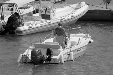 Italy, Sicily, Mediterranean Sea, Marina di Ragusa (Ragusa Province); 4 September 2022, sport fisherman on a motor boat in the port - EDITORIAL