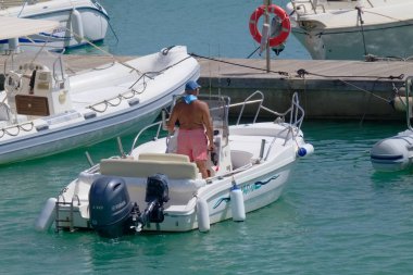Italy, Sicily, Mediterranean Sea, Marina di Ragusa (Ragusa Province); 4 September 2022, sport fisherman on a motor boat in the port - EDITORIAL