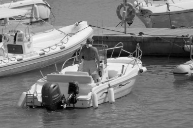 Italy, Sicily, Mediterranean Sea, Marina di Ragusa (Ragusa Province); 4 September 2022, sport fisherman on a motor boat in the port - EDITORIAL