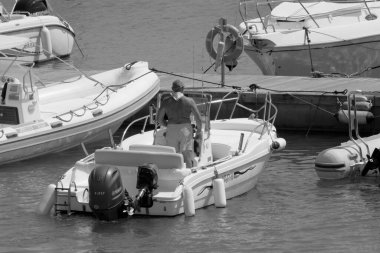 Italy, Sicily, Mediterranean Sea, Marina di Ragusa (Ragusa Province); 4 September 2022, sport fisherman on a motor boat in the port - EDITORIAL