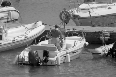 Italy, Sicily, Mediterranean Sea, Marina di Ragusa (Ragusa Province); 4 September 2022, sport fisherman on a motor boat in the port - EDITORIAL