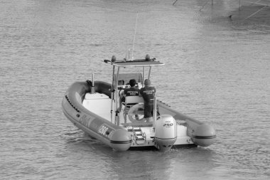 Italy, Sicily, Mediterranean Sea, Marina di Ragusa (Ragusa Province); 4 September 2022, men on a rubber boat in the port - EDITORIAL