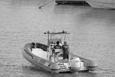 Italy, Sicily, Mediterranean Sea, Marina di Ragusa (Ragusa Province); 4 September 2022, men on a rubber boat in the port - EDITORIAL