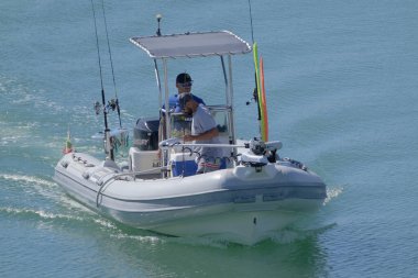 İtalya, Sicilya, Akdeniz, Marina di Ragusa (Ragusa Eyaleti); 11 Eylül 2022, limandaki lastik bir teknede balıkçılar - EDITORIAL