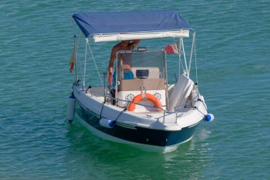 İtalya, Sicilya, Akdeniz, Marina di Ragusa (Ragusa Eyaleti); 14 Eylül 2022, limandaki bir motorlu teknede adam - EDITORIAL