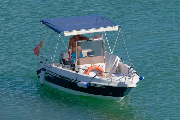 İtalya, Sicilya, Akdeniz, Marina di Ragusa (Ragusa Eyaleti); 14 Eylül 2022, limandaki bir motorlu teknede adam - EDITORIAL