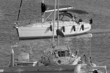 İtalya, Sicilya, Akdeniz, Marina di Ragusa (Ragusa Eyaleti); 5 Ekim 2022, limandaki bir yelkenli teknesinde adam - EDITORIAL