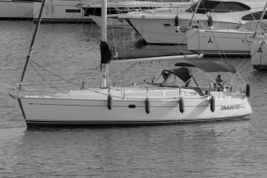 İtalya, Sicilya, Akdeniz, Marina di Ragusa (Ragusa Eyaleti); 5 Ekim 2022, limandaki bir yelkenli teknesinde adam - EDITORIAL