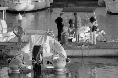 İtalya, Sicilya, Akdeniz, Marina di Ragusa (Ragusa ili); 5 Ekim 2022, limanda insanlar ve motorlu tekneler - EDITORIAL