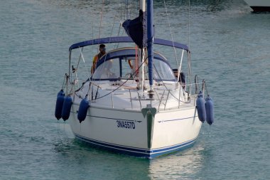 İtalya, Sicilya, Akdeniz, Marina di Ragusa (Ragusa ili); 6 Ekim 2022, limandaki bir yelkenli teknesinde erkekler - EDITORIAL