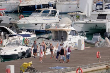 İtalya, Sicilya, Akdeniz, Marina di Ragusa (Ragusa Eyaleti); 9 Ekim 2022, limandaki insanlar ve lüks yatlar - EDITORIAL