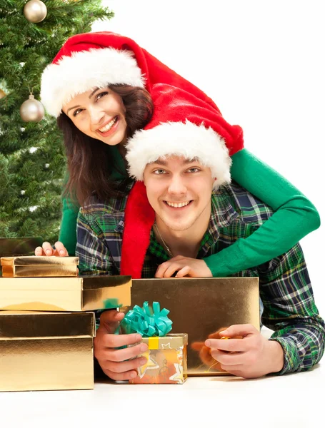 Jovem casal feliz perto de uma árvore de Natal. — Fotografia de Stock