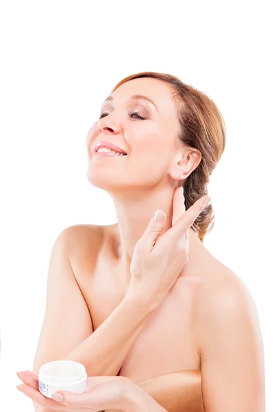 Beautiful adult woman applying cream on face. — Stock Photo, Image