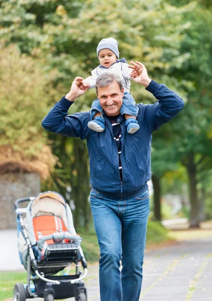 Grandfather Giving Grandson Ride On Back — Stock Photo, Image