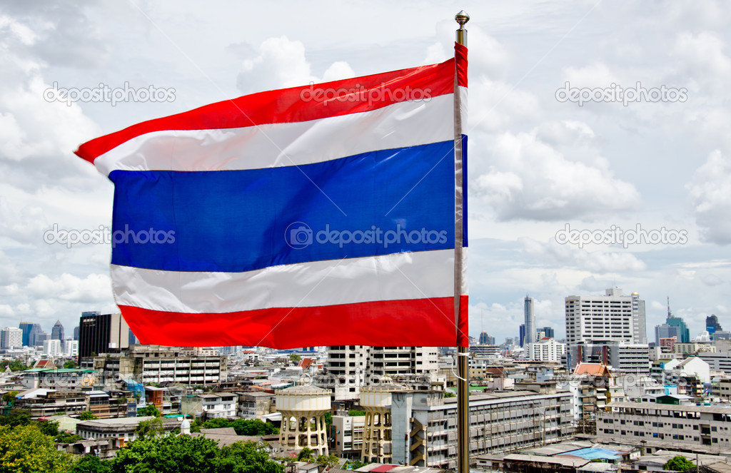 Waving Thai flag with city background