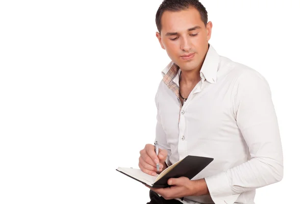 Young man making notes — Stock Photo, Image