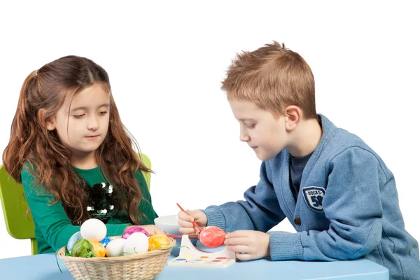 Brother and sister decorating Easter eggs — Stock Photo, Image
