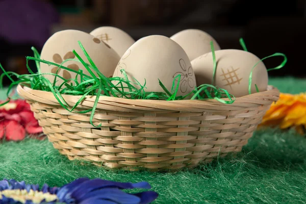 Five eggs in a basket on green fake grass — Stock Photo, Image