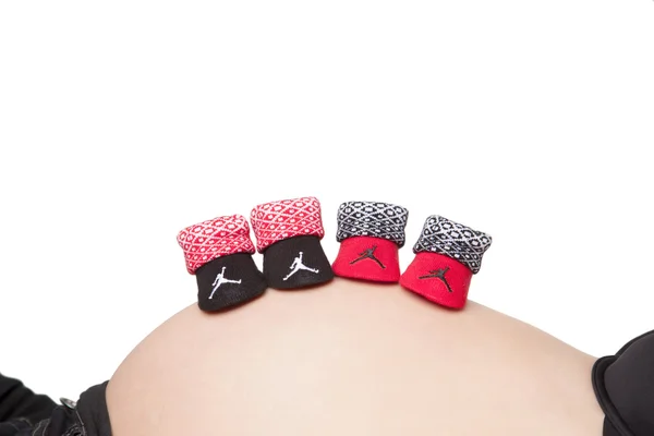 Pregnant belly with baby booties — Stock Photo, Image