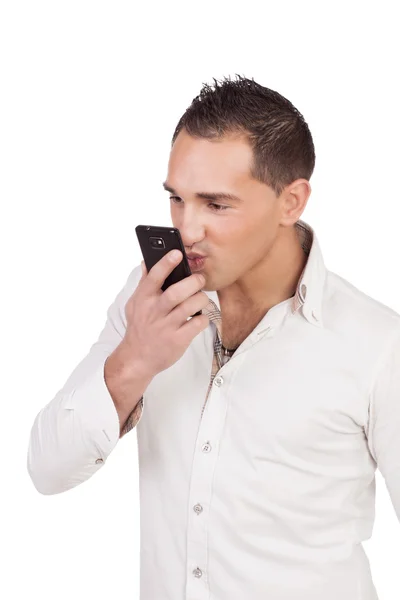 Romantic man blowing a kiss at his mobile — Stock Photo, Image