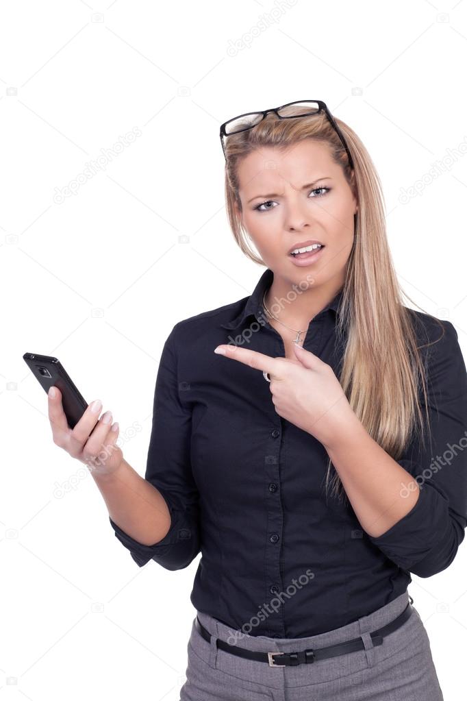 Frowning woman pointing to her mobile