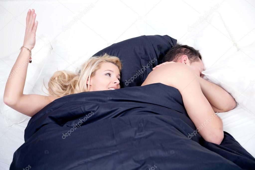 Frustrated woman in bed with her husband