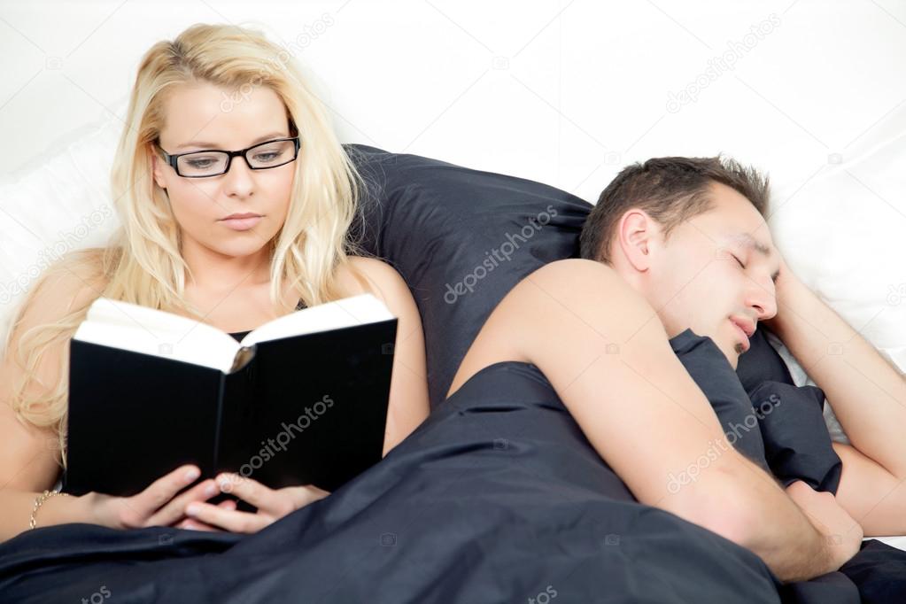 Couple reading and sleeping in harmony