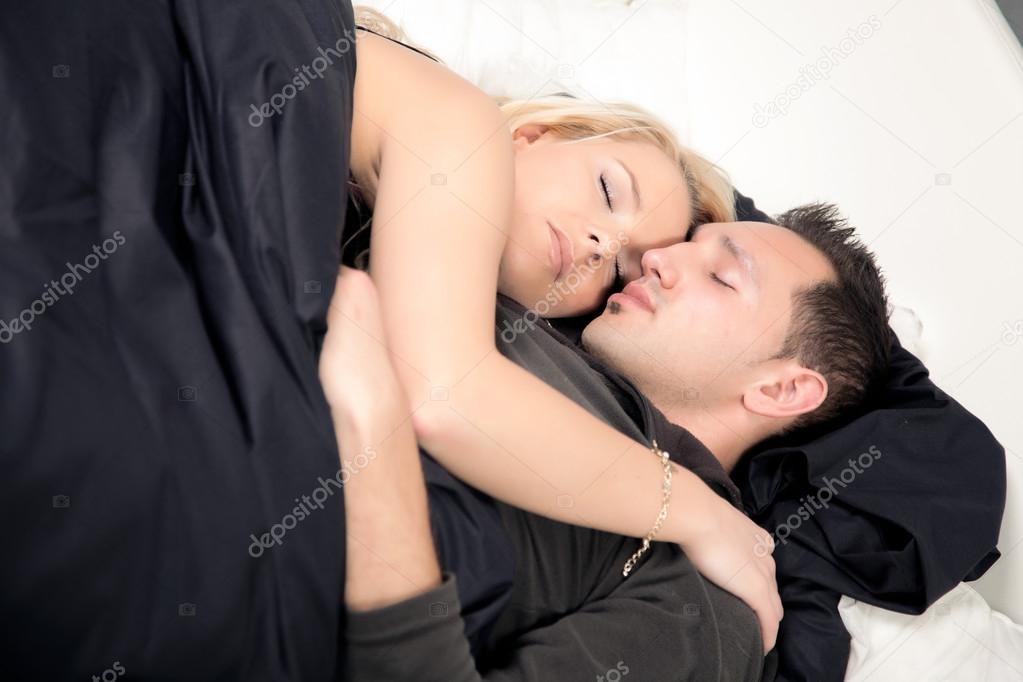 Young couple sleeping peacefully in bed